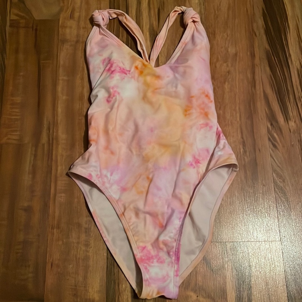 A one piece swim suit that is low cut and has padding, women’s S, from decree.